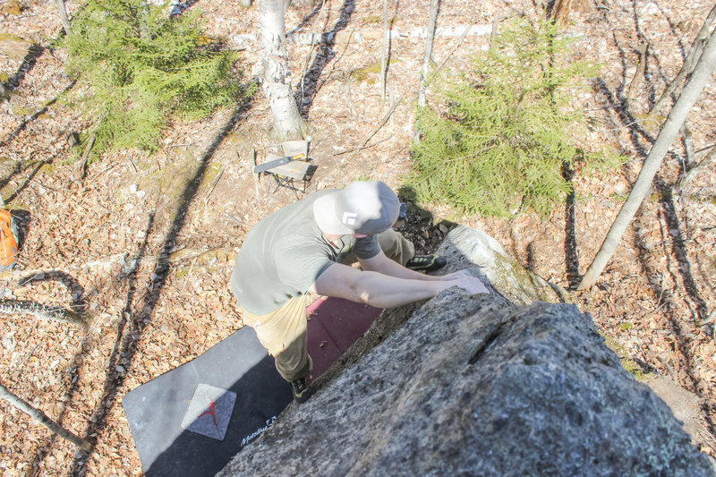 Working up the arete after passing over the starting bulge.