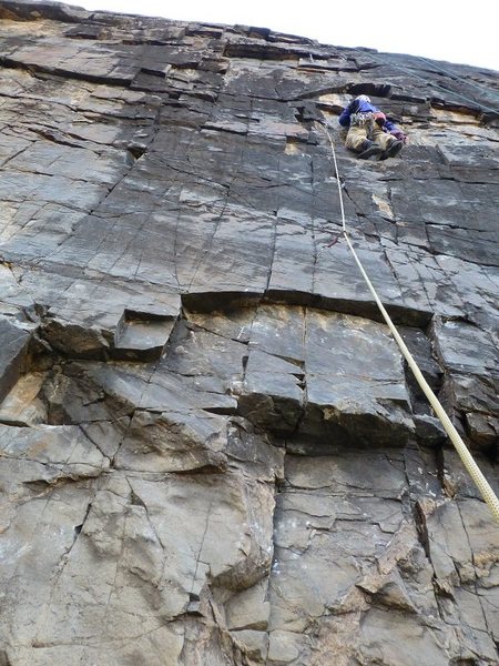 Bo on the superb black rock of pitch 7, off of the Veranda.  Note the key yellow Loweball protecting the first moves off the ledge!