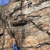 my friend is below the crux moves, clipping the fourth bolt. the route goes up left then slight right to the chains. a nice and pumpy climb