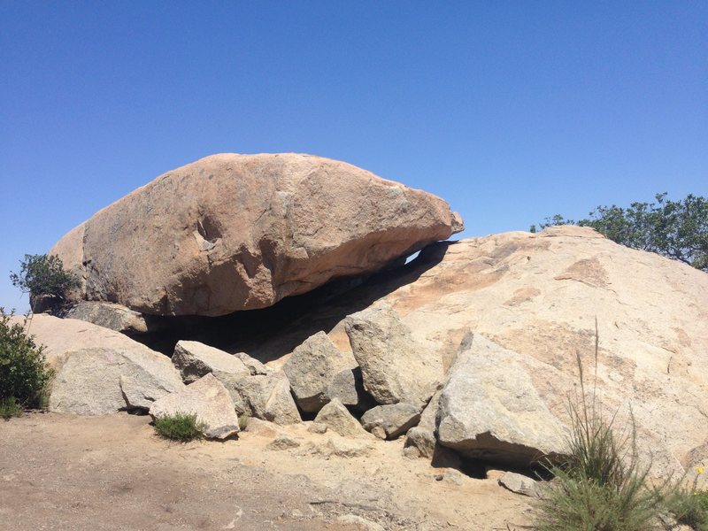 The route is inside this boulder. Walk around the left to access a short 4th class downclimb to the start.