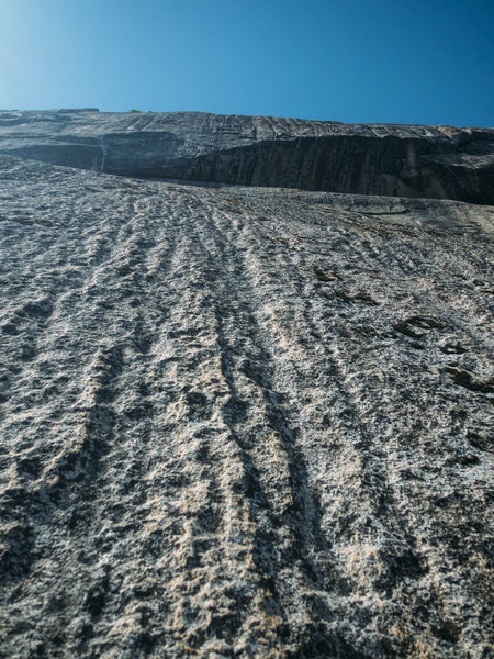 The dimpled slab at the top. The last bolt is way out of sight below and there's nothing in sight above. Probably close to 100' of unprotected 5.3 slab to finish off the route.
