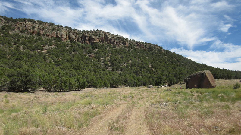 Area view with boulder in lower right and trad routes in the upper left