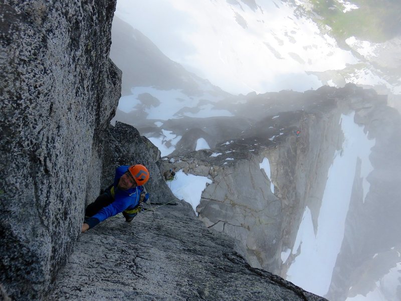Climber leading Pitch 1 of the Gendarme, with the North Ridge stretching below.