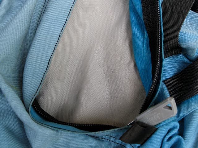 There is some abrasion on the thinner material inside the pack that separates the back pockets from the main compartment. This is from pressure washing the PU coating off. Abraded but not tore.