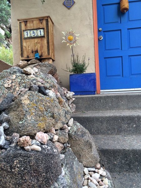 Front door, custom rock entryway built with stone from the property and a few other places around the world.