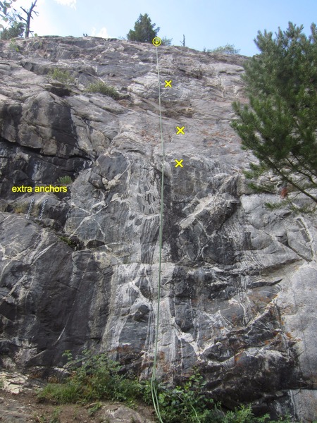 The extra anchors left of the route. The first 3 bolts are marked.
