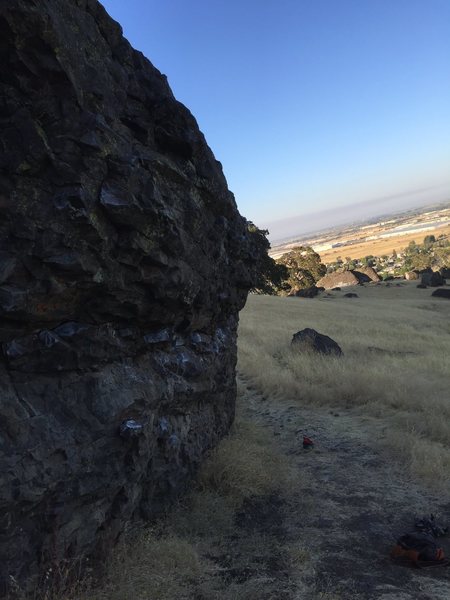 Side view of Boulder of bloody madness with stonewall in the back round.