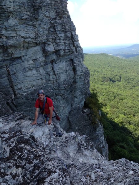 Climber Joe climbing onto the ramp near the top of pitch #2. Crows Nest at the top of Sentinel pitch #1 in the background to the right.
