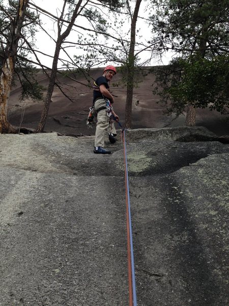 Rap station from the tree ledge to the base. Two ropes required. Rings are left of Entrance Crack.