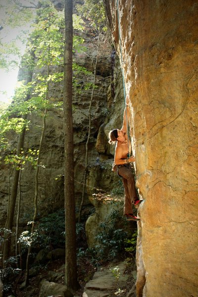 Climber working through the tough moves down low.