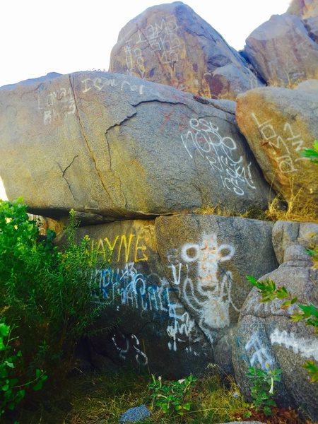 Just to the left of the main face, this can be a nice bouldering problem with some weed whacking!