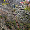 Photo#14 - P7  S Matz climbs up the slab, then will traverse right to the "ugly corner". 
