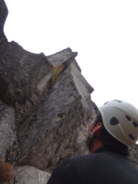 Ben Smith, at the belay ledge on top of "Entrance Crack" considering where to go for a second pitch.