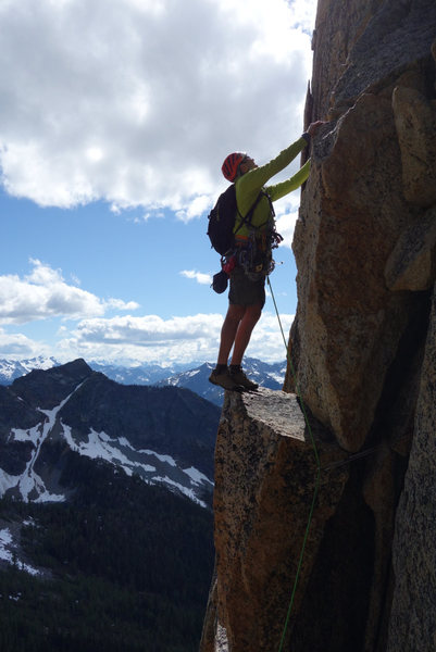Scouting the next moves after coming out of the short, awkward chimney at start of pitch 2.