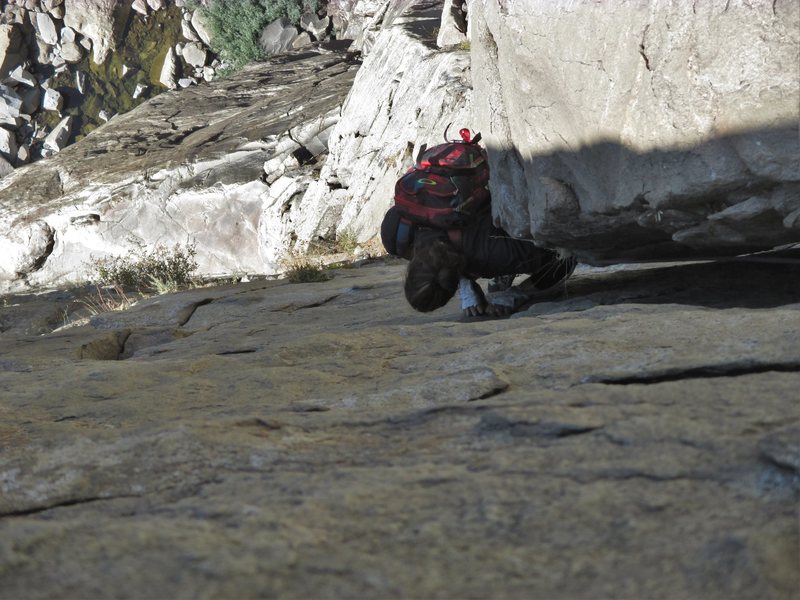 Maxime wedges in a left shoulder and gets feet on the edges for the P4 crux. No actual hard climbing yet.