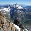 Climbers on the Shoulder Ridge with Weisshorn Group peaks seen in the background.
