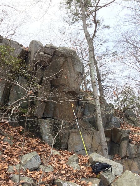 Tall, steep arete in the hillside of the left leg, off of the green and/or blue trail.