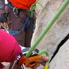 A 70m rope just makes it to the ground for a toprope belay on this wall.