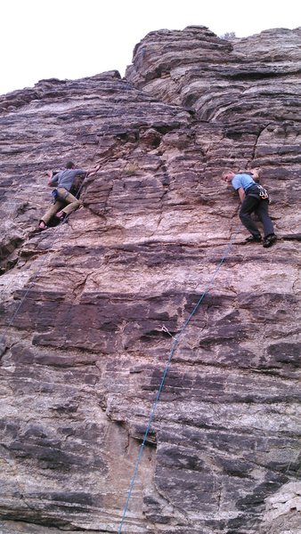 Photo showing the upper half of Scarface.  Climber on the left is working the moves on top rope. 