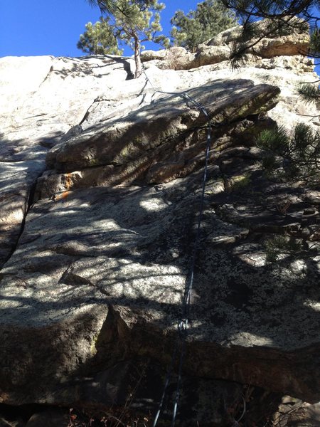 The route goes to the left of the rope at the bottom and to the right of the rope at the second overhang.