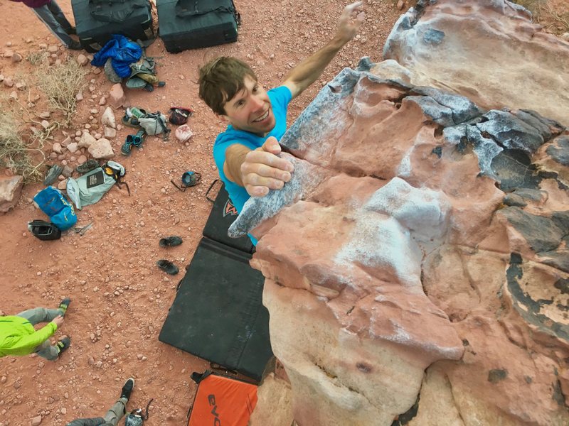 Random guy named Kevin hangs off the topout jugs of The Pearl (V5).