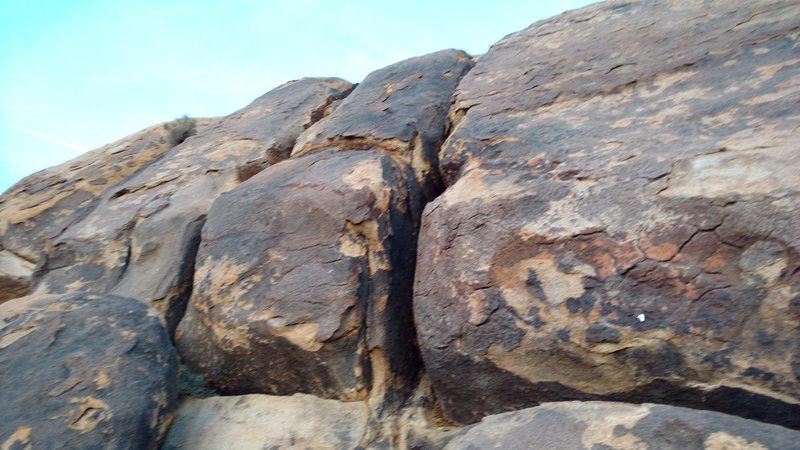 Anyone recognize this route? There are several routes nearby with this same character (brief crux low followed by low angle and well featured holds). A summit register can be found above this formation.