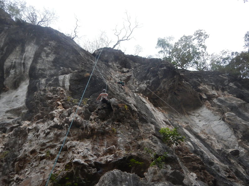 Hans Dampf (left) ascents the cobble-like overhang to gain the face; Heisenberg gains the face on the right. The anchors to Hans are above the roof (you traverse over to them), while Heisenberg's anchors are just inside the roof, making a fun pumpy finish.