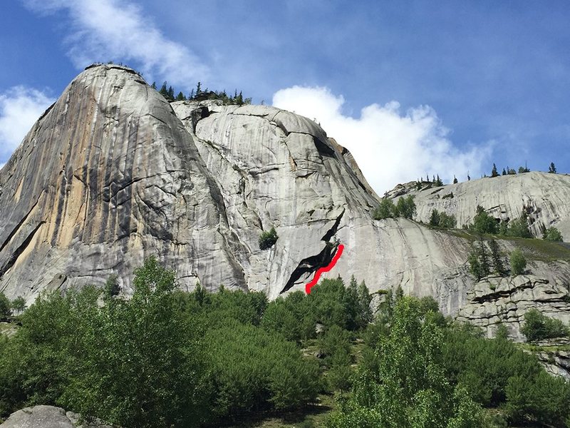 Start about 30m right of the massive chimney system that forms the elephants ears. This route climbs the large roof system that is accessed by a slab. Start under a short thin finger dihedral that reaches the ledge below the slab. <br>
Dane Schellenberg and Ji Yun<br>
2 Pitches <br>
1st pitch 45m 5.11+<br>
Climb the short fingers to hands dihedral that leads to a ledge and then step unto the bolted slab. Follow the slab up into the roof crack and head right into a delicate corner and a fun traverse under the roof. Build a belay once you get to solid hand jams just before the roof widens and turns up and right. Hanging belay.<br>
Anchor: #1 to #4<br>
2nd Pitch 15m 5.10-<br>
Climb the sometimes burly corner until you get to a tree. You could belay off the tree, but a gear anchor is probably better.<br>
Anchor: #.3 to #1<br>
Gear: #000 to #4 (a #5 is useful), small wires and RPs<br>
3rd Pitch UNCLIMBED <br>
This route could easily continue up to the large ledge on the elephants trunk. Looks very wide. Bring yer sixes!<br>
Descent: Rappel off of the small tree. If the long sling anchor is no longer there (f’ing mice) then you should leave one of your own. If you rappel directly off the tree the rope gets very easily jammed and won’t pull at all. Rappel about 30m down to a single bolt with a maillon on it. Another 30m rappel takes you to the ground.<br>
