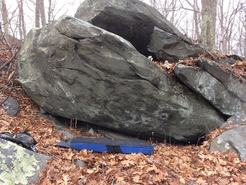 There are 2 other potential routes -- a possible V2 from right to left on the rail, same top out, and a sit starting crimpy V3-ish route on the left arete. Name em if you climb em!