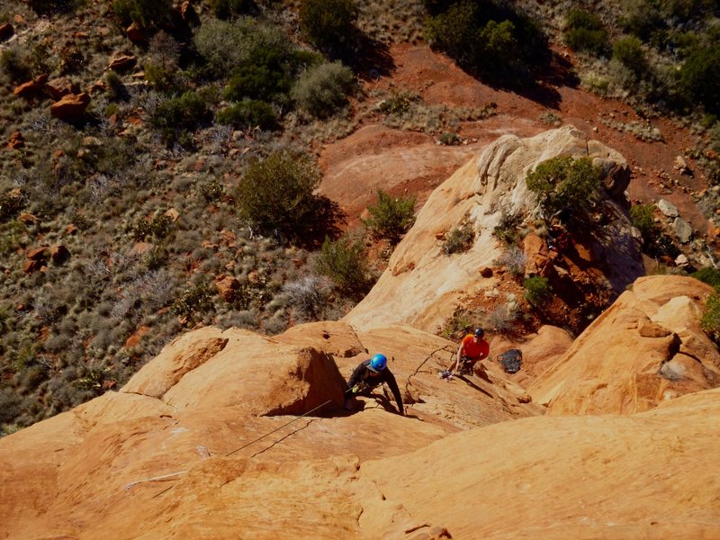 Nate (blue helmet) starting P2 with Alexis (orange shirt) standing in the scoops belay atop P1.