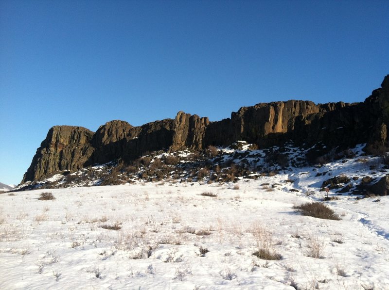 From the approach, note the tall buttress near the "east" entrance and the sunlit face of the Entrance Cracks near the "north" entrance