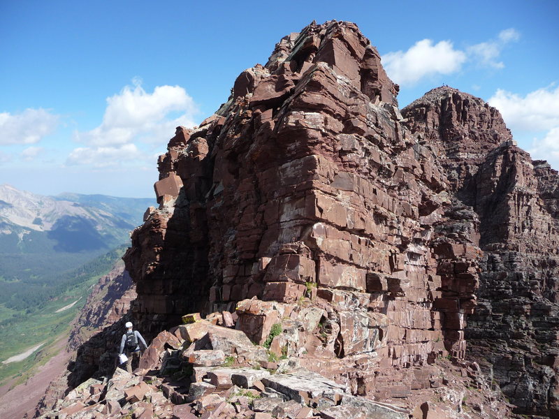 The crux section of the traverse. We climbed up the low 5th Class chimney in the heavily shadowed corner on the left.