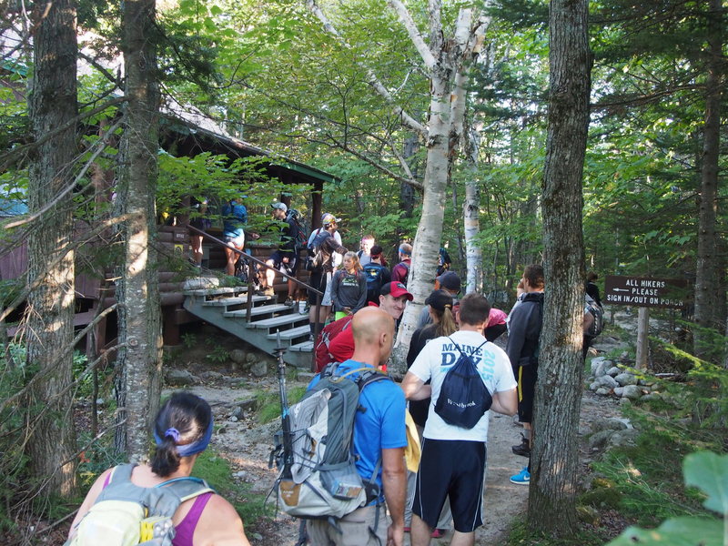 Hikers waiting in line to sign the "sign-in/sign-out" register book at Roaring Brook Ranger station. Don't be discouraged, the crowds dissipate! 