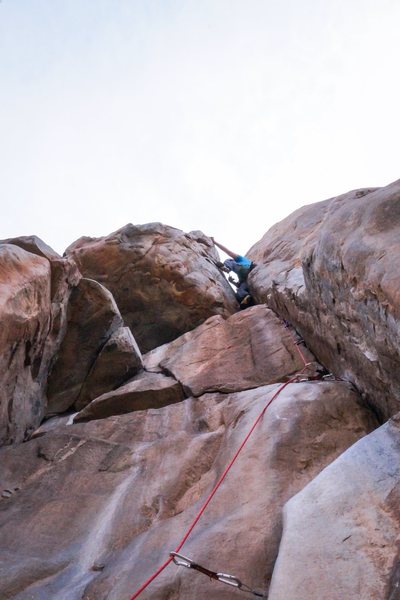Find the right nut while hanging out between to large pieces of rock just before pulling up over the lip to the anchor of Gallwas Crack.