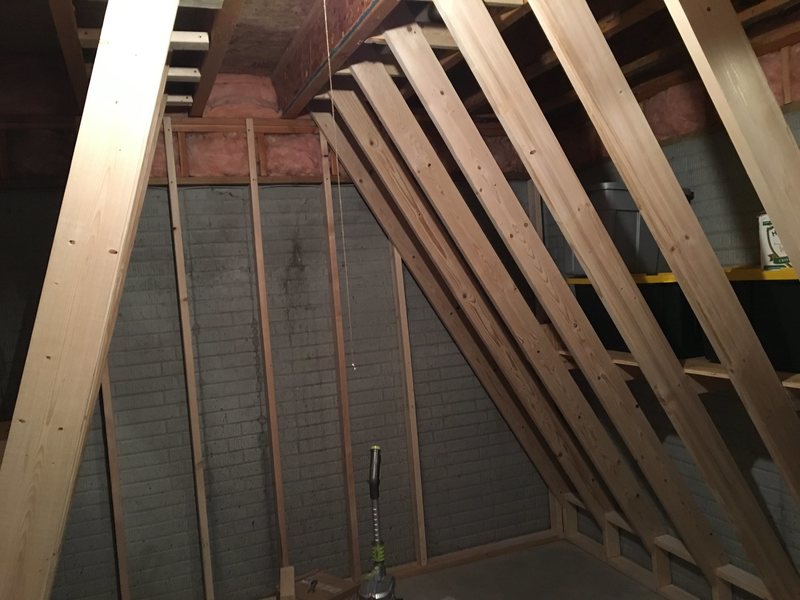 Construction of my climbing wall, 15-degree overhang on left, 30-degree on right, vertical on the back wall.