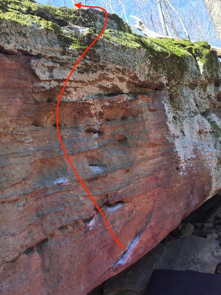 Start on nice lip, toe under the boulder, and high left toe, work your way up and top out.