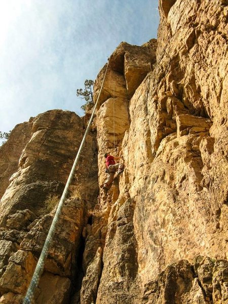 Reggie cleaning the route and marking the bolt placements.