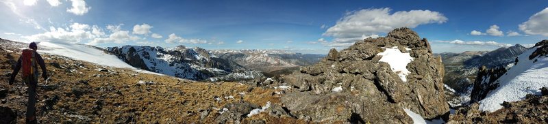 Hiking off to find a snowy descent; backside of Flattop with the route topout on the right.