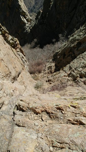 Looking down at where the route starts. It is "right around the corner" East from Hummingbird Saddle. Go through some bushes to a flatter ledge to get climbing shoes on.