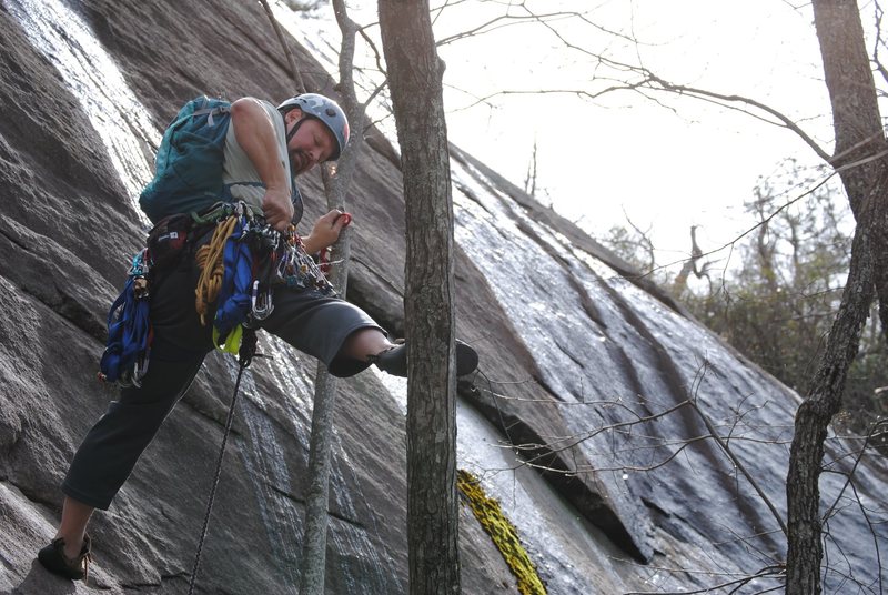 Scouting the route from a tree stem. I tried slinging the tree to protect the crux, but the swing would not have been fun so I pulled it sharp.