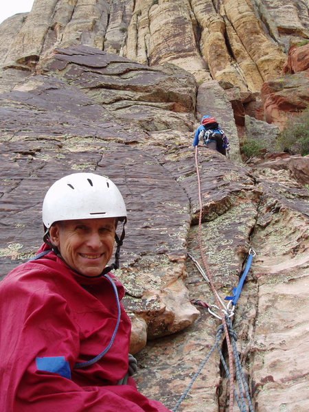 (Route Photo) WHY is this man smiling? As the wise, old climber he is: he's managed to belay, not lead, the crux pitch. (Note the all-nut trad belay.)