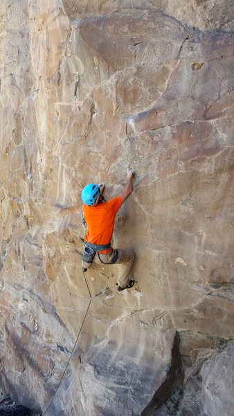 Josh sets up for the final move of the first crux.