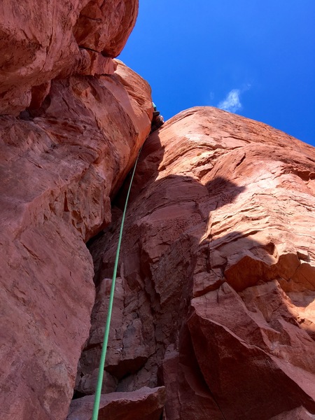 Leading the offwidth. Photo taken from first ledge en route.