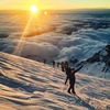 Climbers high on Rainier at sunrise after climbing the Ingraham Direct.