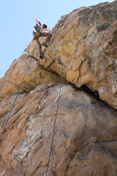 Dan rappelling and cleaning up after a successful lead