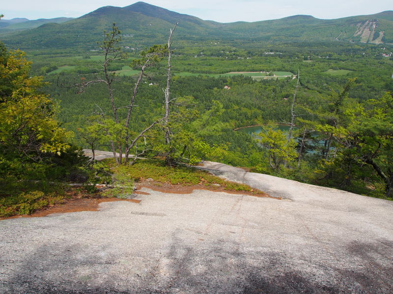 Looking down from 100 ft south of path. Scramble down and viewer's left to the left end of a large tree island. You'll then be just about exactly at the top of "The Last Wave".