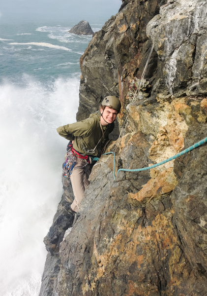 Nick starting off on the 5th pitch, surrounded by waves.
