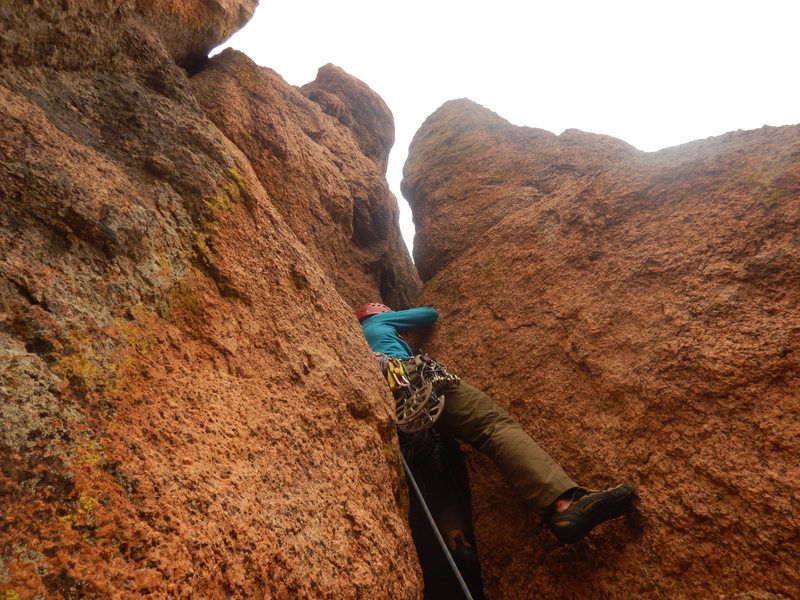 Entering the squeeze chimney on pitch 2.