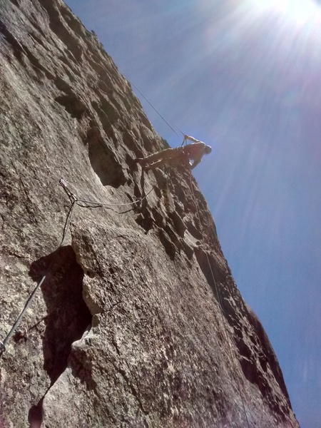 Cleaning on rappel. Beware! There is a lot for the rope to get hung up on, and the rock is quite sharp.