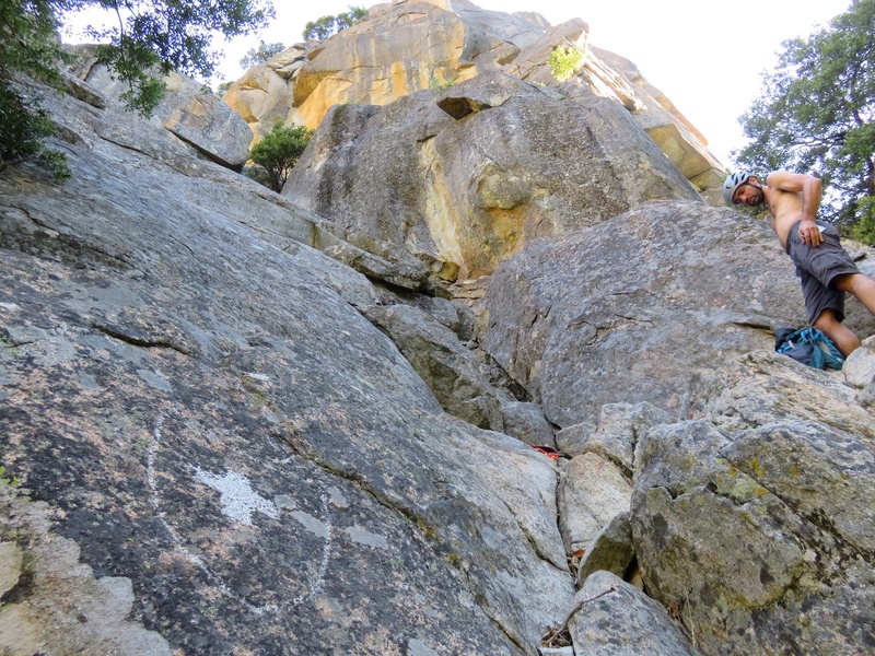 The start of the route is marked by a cross etched into the rock.